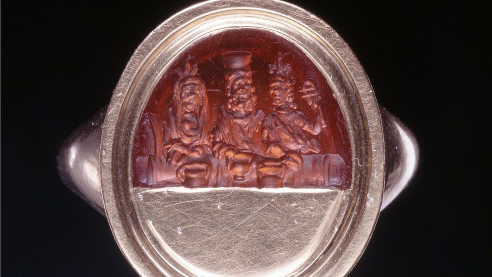 A Roman sard gem engraved with representations of the "divine couple" Serapis and Isis