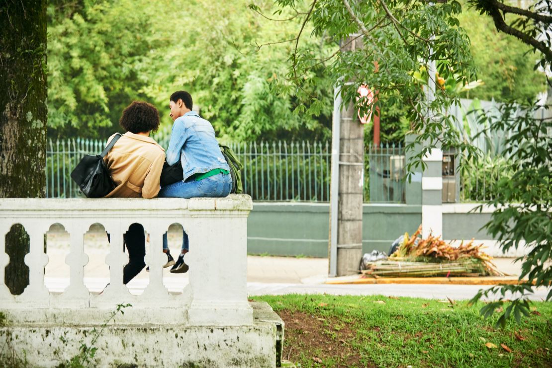 Rear view shot of a young couple relaxing outdoors on vacation