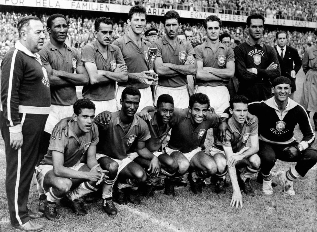 The victorious Brazil team with the trophy: (back row, l-r) Coach Vicente Feola, Djalma Santos, Zito, Bellini, Nilton Santos, Orlando, Gilmar  (front row, l-r) Garrincha, Didi, Pele, Vava, Mario Zagallo, trainer.